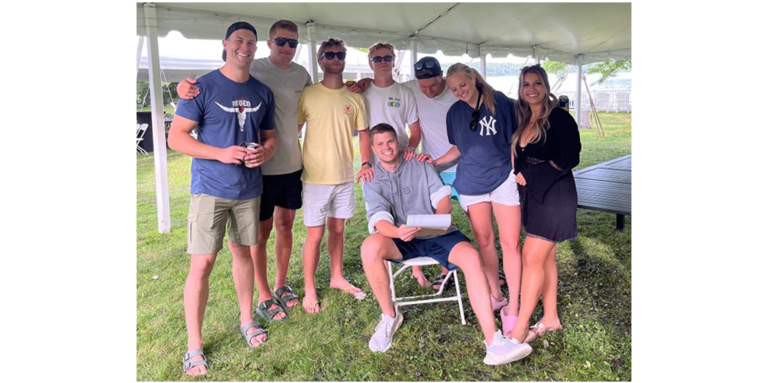 Matt Simonot (seated) with his friends, setting up for the CNIB Lake Joe Cookout with Cuddy event. Matt’s sister, Lara is beside Matt, second from the right.