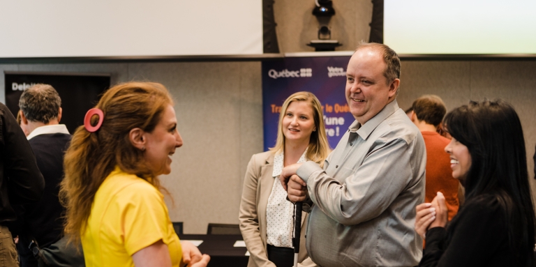 A group of people speaking in business attire. 