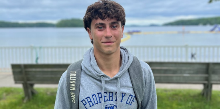 Zachary Levin smiles as he stands in front of the Lake Joe waterfront.