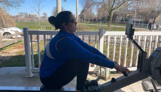 Victoria Nolan practices on an outdoor rowing machine on her back porch.