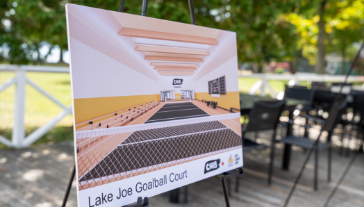 Artist rendering of the new CNIB Lake Joe Goalball Court showcased on an easel on the deck at CNIB Lake Joe.