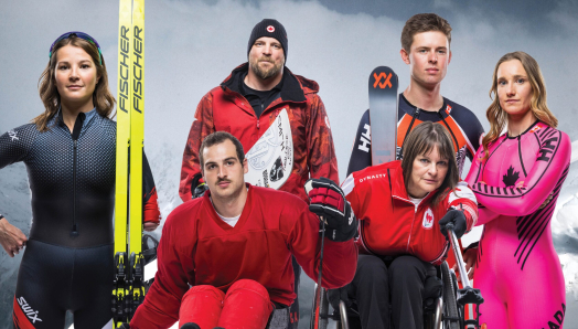 Team Canada Paralympic athletes stand together in their official athletic gear, posing in front of a snowy mountain landscape.]
